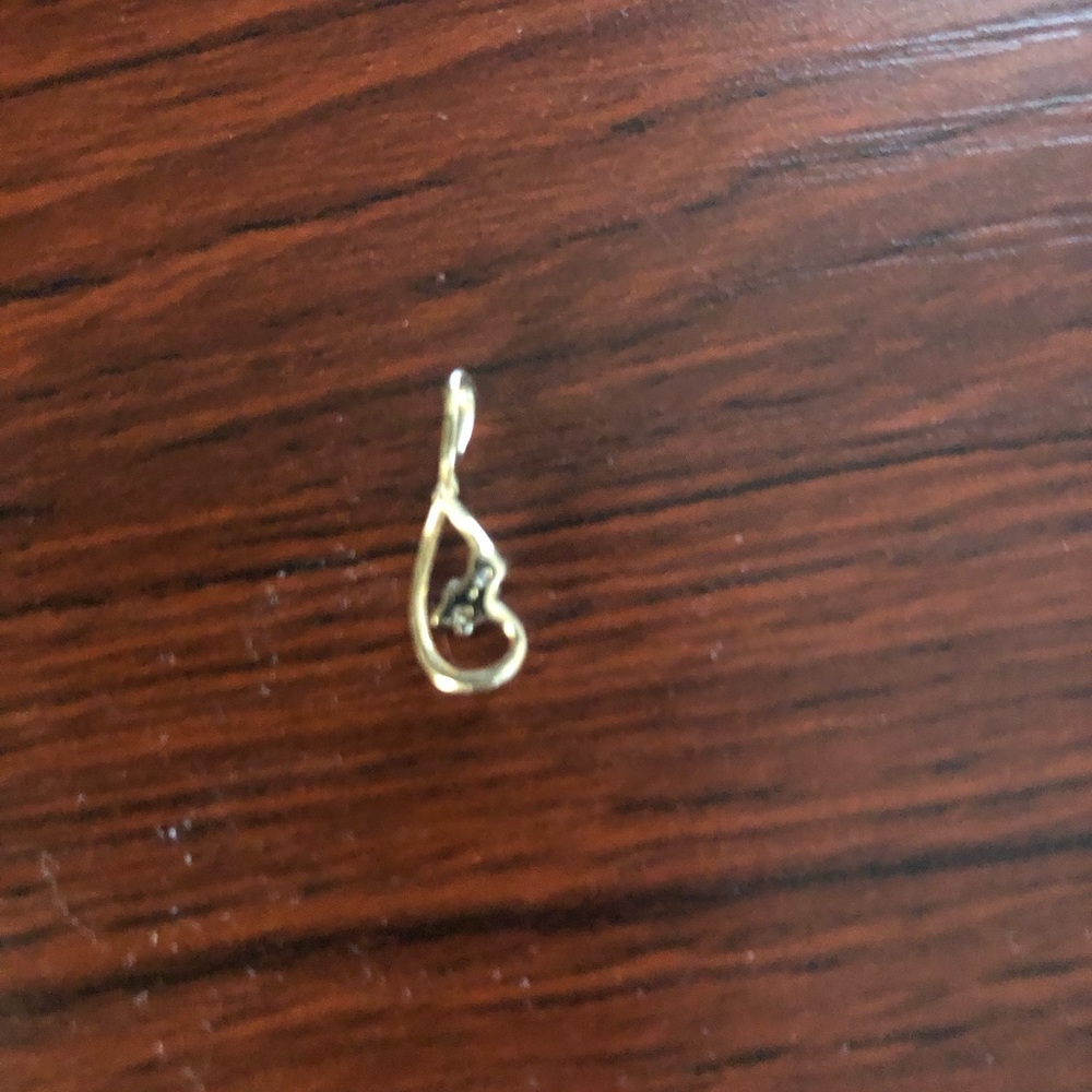 Pretty diamond and gold pendant.  No markings.